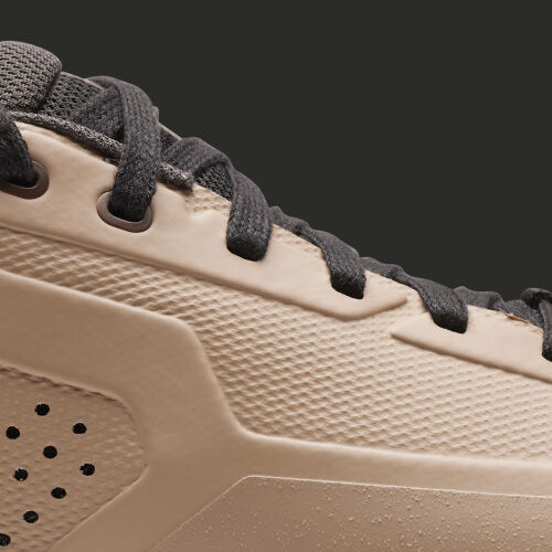 Close up of a tan mountain bike shoes showing the upper molded construction.